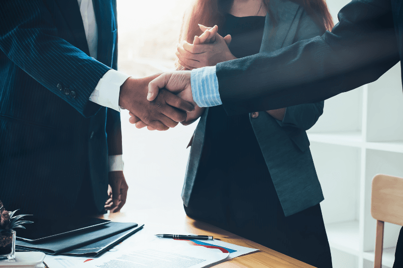 Business professionals shaking hands in a modern office